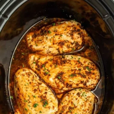 Tender slow cooker chicken breasts ready to serve with herbs and spices