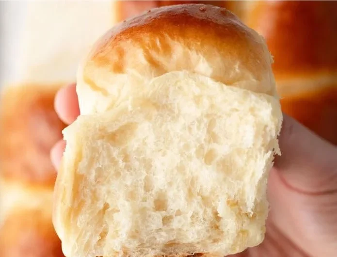 Freshly baked sweet Hawaiian bread rolls on a wooden table