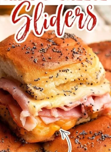 Baked Ham and Cheese Sliders with melted cheese and ham on a platter