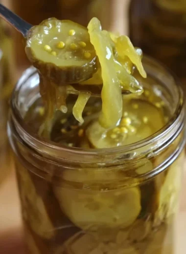 Jar of Grandma's homemade bread and butter pickles on a rustic table
