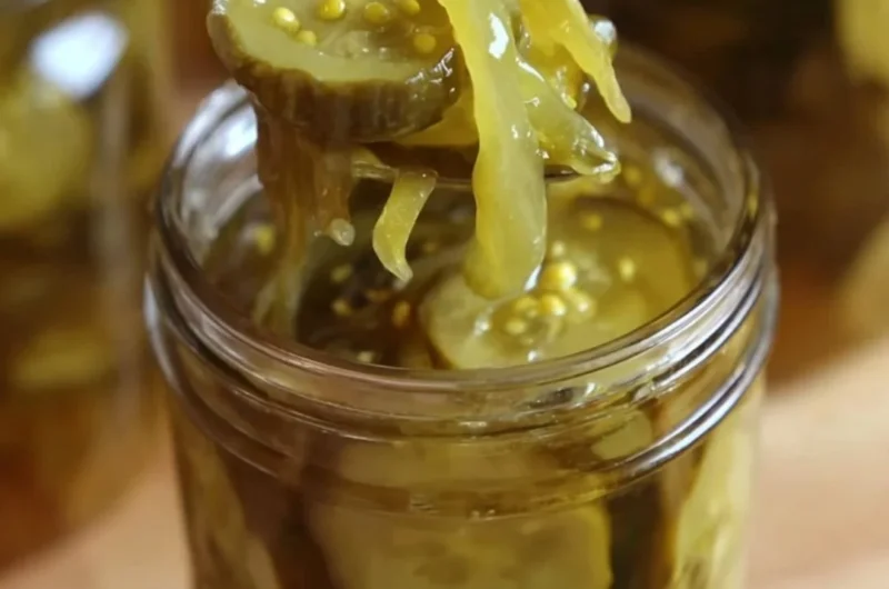 Jar of Grandma's homemade bread and butter pickles on a rustic table