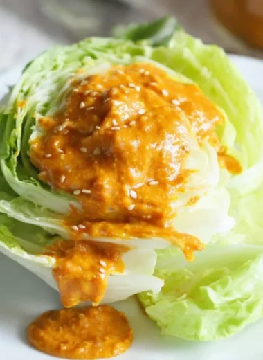 Bowl of Japanese carrot ginger dressing on a rustic table.