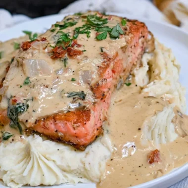 Delicious Marry Me Salmon dish garnished with herbs and served on a plate.