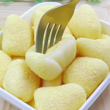 Delicious pan-fried fresh milk mochi, soft and chewy texture, served on a plate.