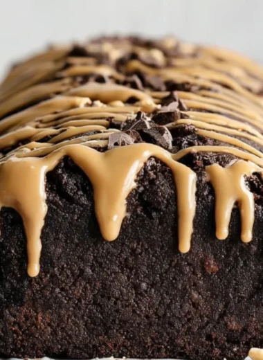 Peanut Butter Chocolate Banana Bread topped with chocolate chips and sliced bananas
