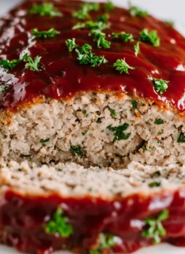 Delicious turkey meatloaf served on a plate with green garnish