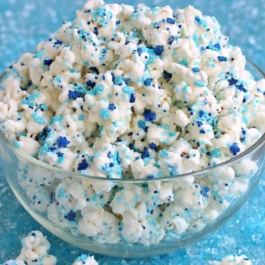 Bowl of Winter Wonderland White Chocolate Popcorn topped with festive sprinkles
