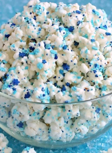 Bowl of Winter Wonderland White Chocolate Popcorn topped with festive sprinkles