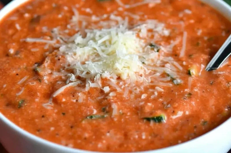 Bowl of Zucchini Tomato Soup garnished with fresh herbs