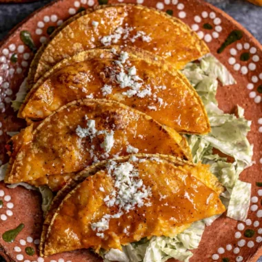 Plate of authentic potato tacos topped with fresh ingredients