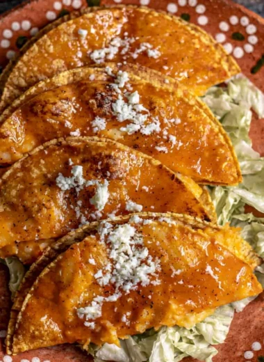 Plate of authentic potato tacos topped with fresh ingredients