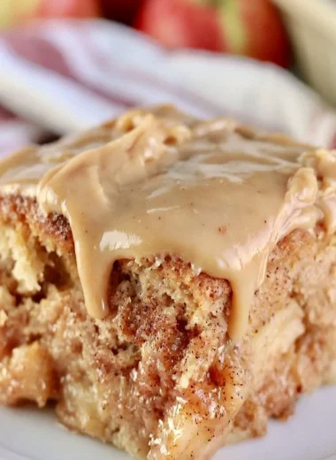 Deliciously moist Apple Dapple Cake topped with cinnamon and nuts.