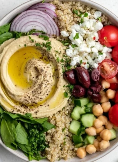Delicious cozy Mediterranean hummus bowl with fresh vegetables and pita