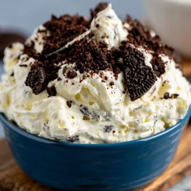 Cozy Oreo Fluff dessert in a bowl topped with crushed Oreos and whipped cream