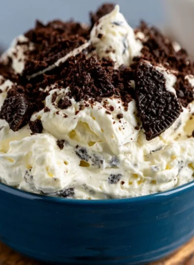 Cozy Oreo Fluff dessert in a bowl topped with crushed Oreos and whipped cream