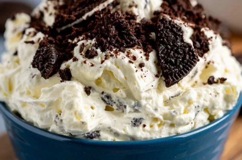 Cozy Oreo Fluff dessert in a bowl topped with crushed Oreos and whipped cream