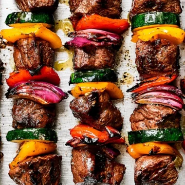 Cozy steak kabobs recipe featuring grilled steak and fresh vegetables on skewers.