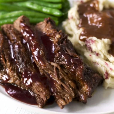 Crock pot chuck roast served with vegetables and gravy