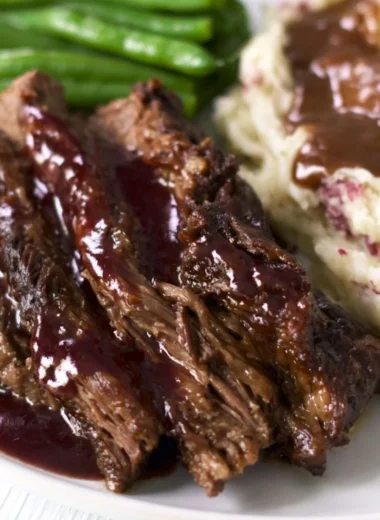 Crock pot chuck roast served with vegetables and gravy