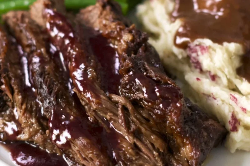 Crock pot chuck roast served with vegetables and gravy