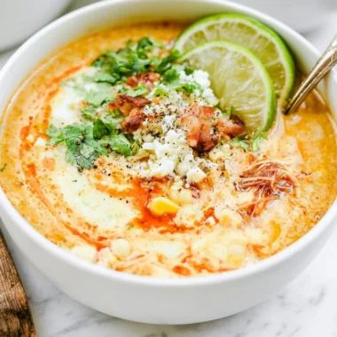 Bowl of Slow Cooker Mexican Street Corn Soup garnished with cilantro and lime