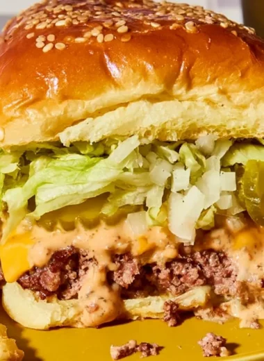 Delicious Cozy Big Mac Sliders served on a wooden board with fresh ingredients