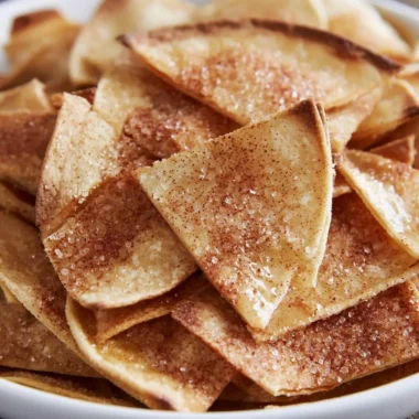 Cozy cinnamon sugar tortilla chips stacked on a plate, ready to be enjoyed.