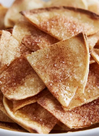 Cozy cinnamon sugar tortilla chips stacked on a plate, ready to be enjoyed.