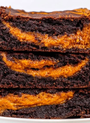 Delicious homemade pumpkin brownies topped with chocolate drizzle