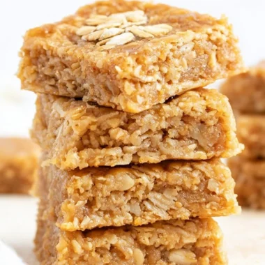 Delicious soft and chewy apple oatmeal bars on a wooden table