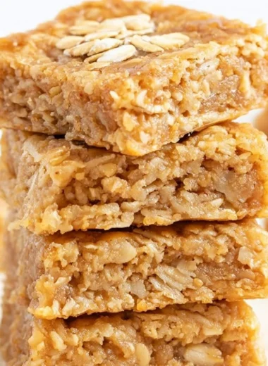 Delicious soft and chewy apple oatmeal bars on a wooden table