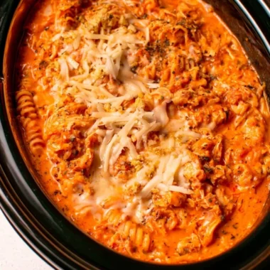 Crockpot Chicken Parmesan Soup served in a bowl with parmesan cheese and basil