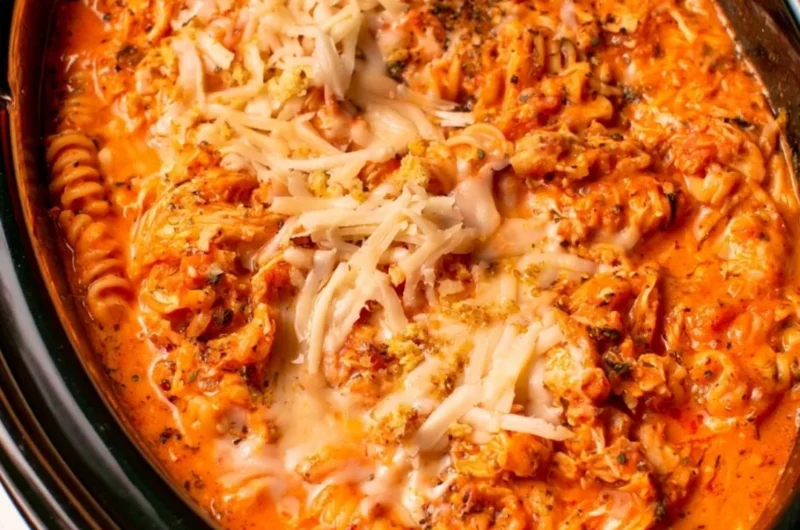 Crockpot Chicken Parmesan Soup served in a bowl with parmesan cheese and basil