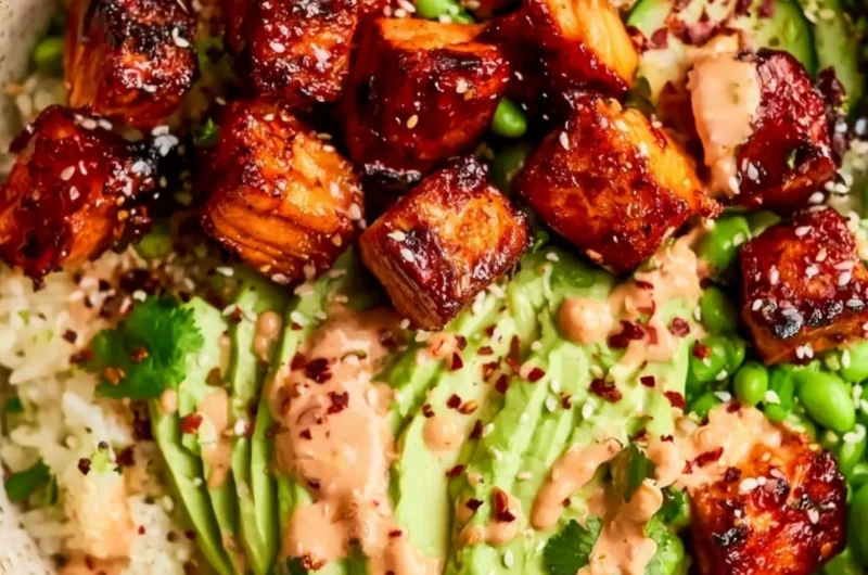 Honey Sriracha Salmon Bowls garnished with vegetables and served in a bowl